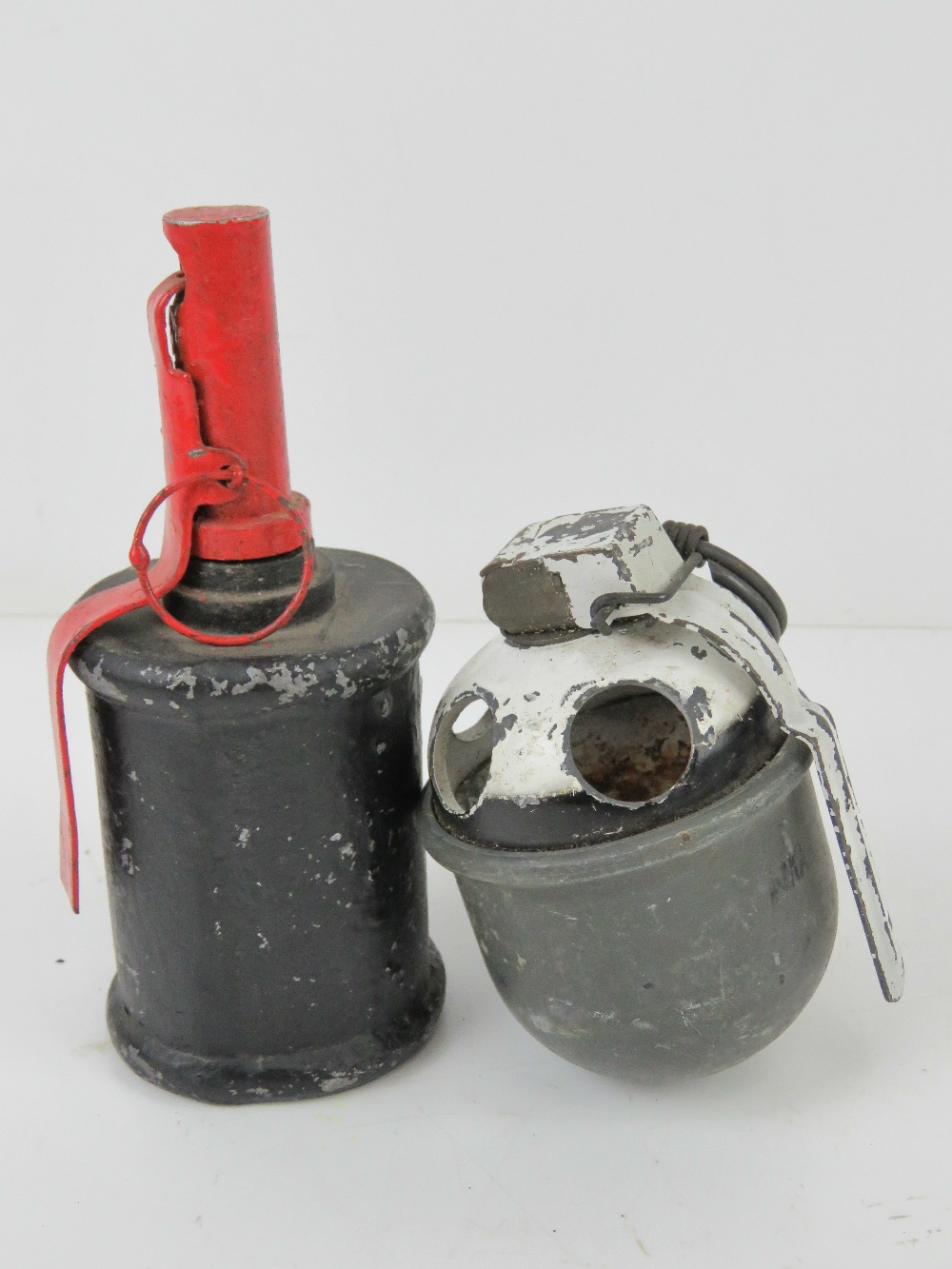 An inert Dutch training grenade with fuse and pin. Together with an inert Soviet RG42 drill grenade.