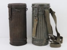 Two WWII German gas mask canisters, contents deficient, one having carry straps.