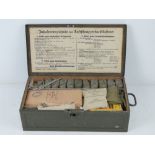 A WWII German Luftschutz First Aid box with accessories inc scissors, torniquet, gauze, GEW.
