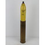 An inert WWI French 75mm HE shell, re-painted, with markings to base of case. Standing 62cm high.