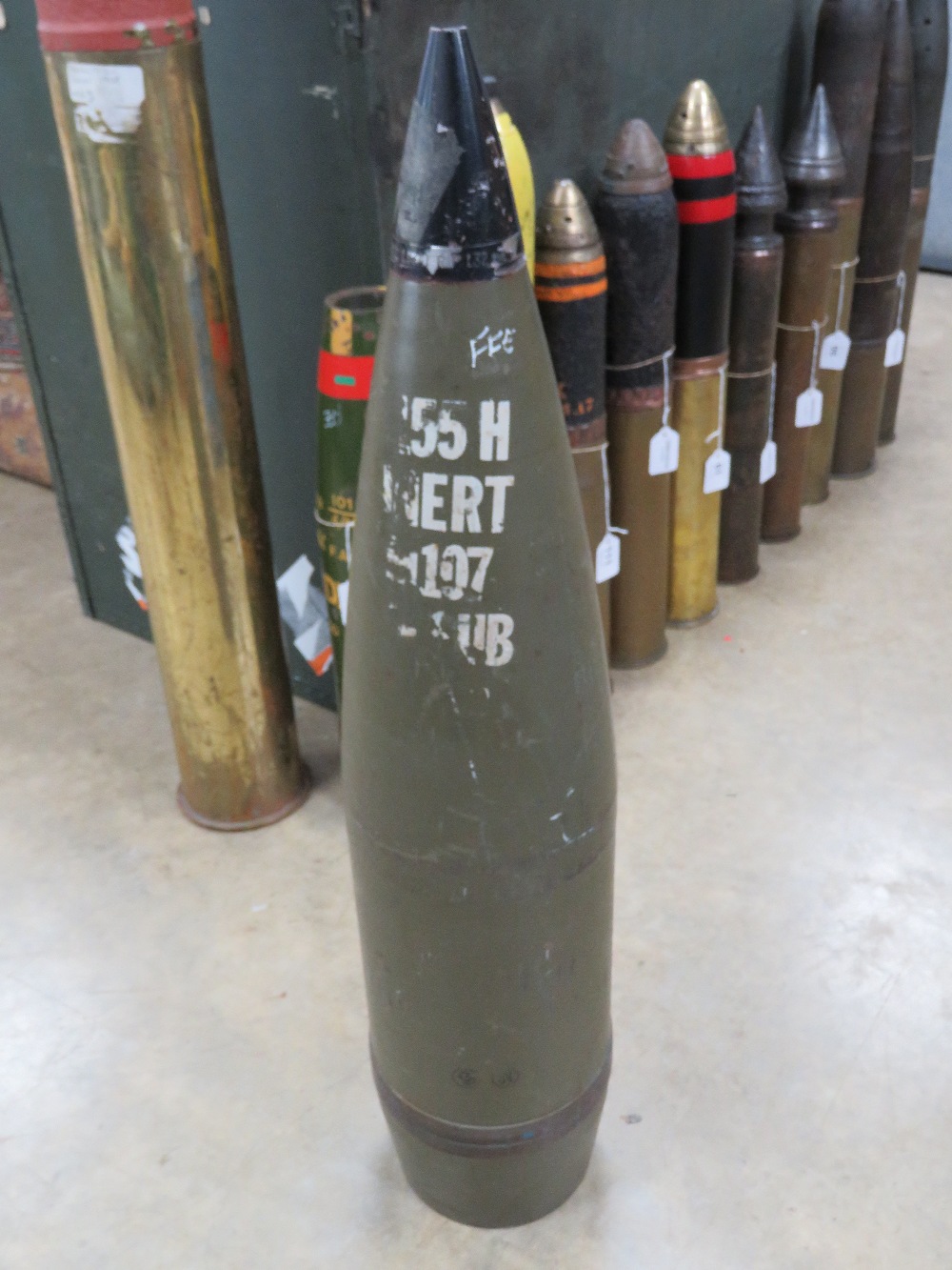 An inert 155mm projectile with fuse standing 70cm high.