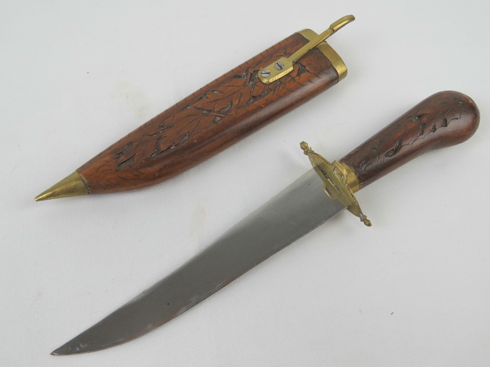 A decorative dagger in carved wood and brass sheath, - Image 6 of 6