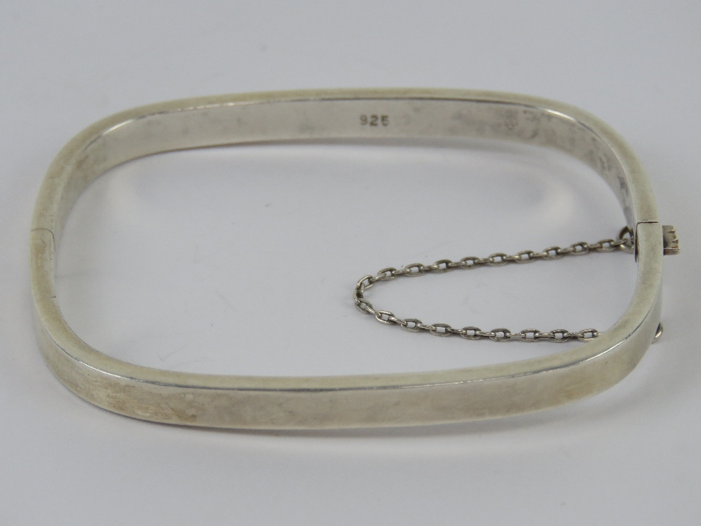 A HM silver rectangular hinged bangle with safety chain, 6 x 5.