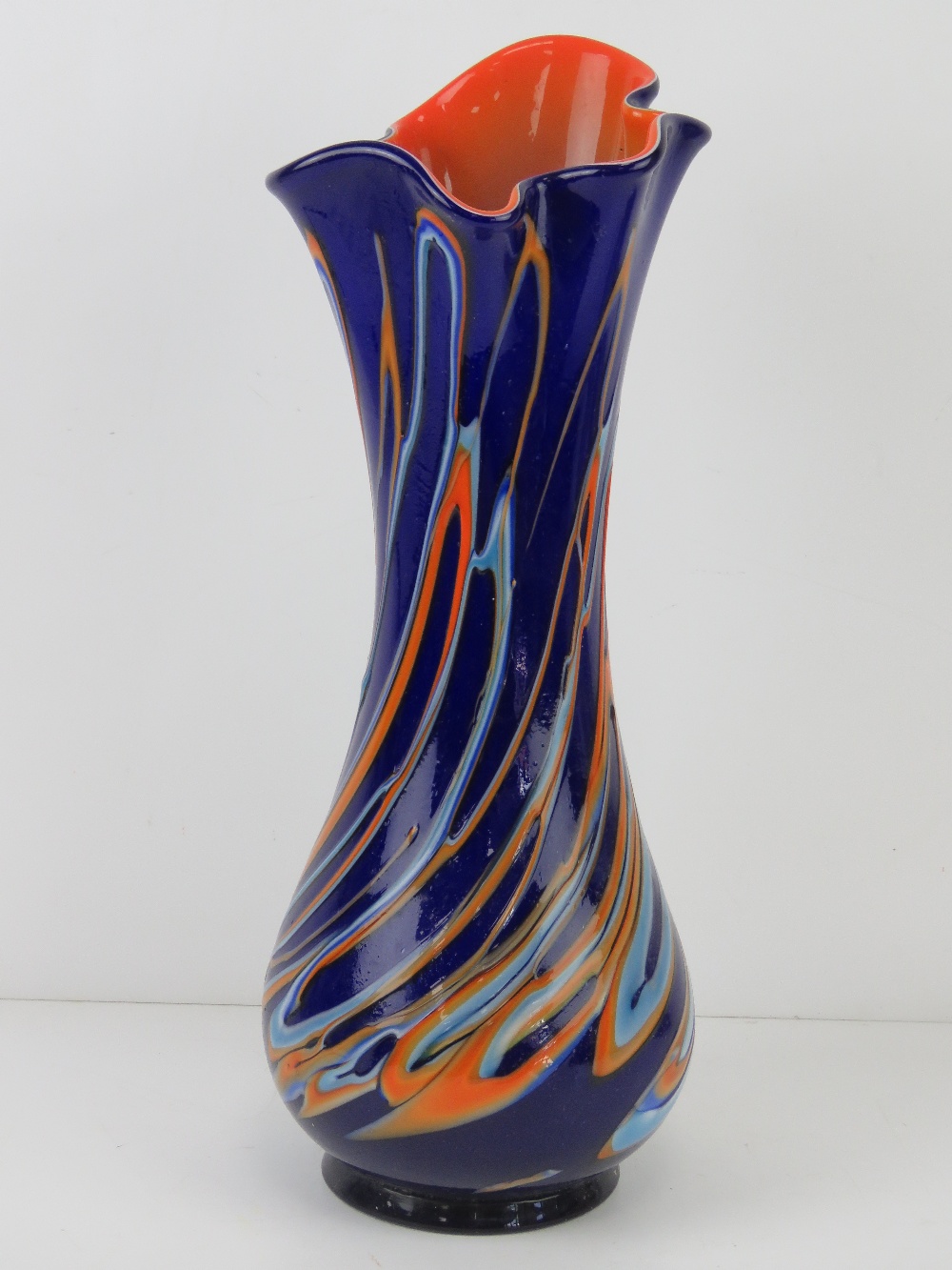 A large hand blown layered glass vase in cobalt blue and orange, standing 43cm high.