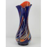 A large hand blown layered glass vase in cobalt blue and orange, standing 43cm high.