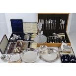 A large quantity of assorted silver plated and other cutlery including part set in wooden canteen,