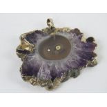 An amethyst geode slice mounted as a pendant, 5 x 3.8cm.