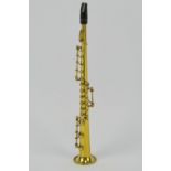 A miniature brass clarinet in case, approx 16cm in length.