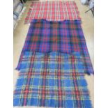 A woollen tartan throw ' The Clan Rug' bearing label upon and measuring 156 x 140cm.