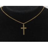 A 9ct gold crucifix having engine turned engraving upon, stamped 9ct,