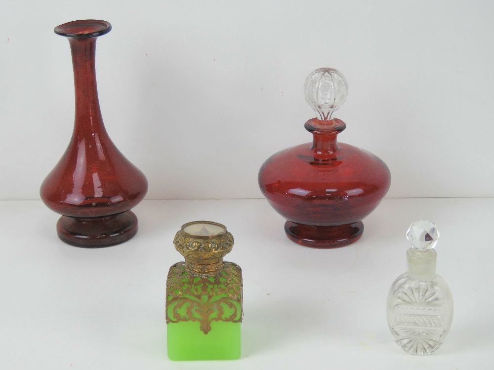 A ruby glass perfume bottle having clear glass stopper together with similar ruby glass vase,