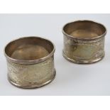 A pair of HM silver napkin rings having floral engraving upon,