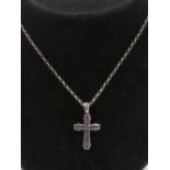 A silver and amethyst cross or crucifix pendant on silver chain,