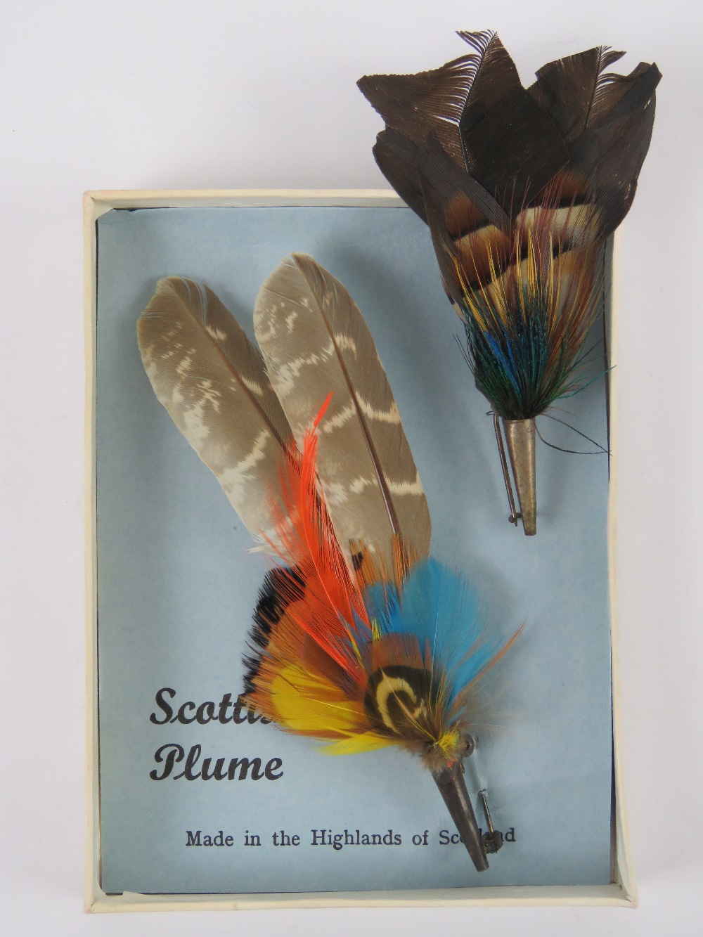 Two Scottish plume brooches one upon original card approx 11cm in length.