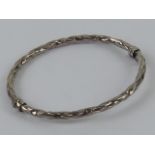 An hallmarked silver hinged bangle having safety clasp, internal dia 6 x 5.