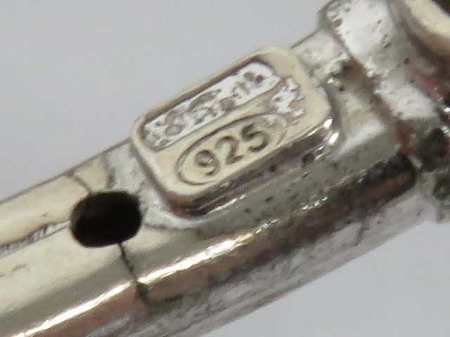 A silver bangle having white stone terminals, stamped 925. - Image 3 of 3