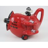 A contemporary Carltonware 'Red Barron' teapot and lid in the form of a biplane.