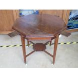 An octagonal oak planter table, square legs tapering to terminate in ceramic castors,