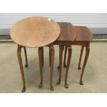 A nest of three 20th century walnut tables raised over slender taping legs, 60,