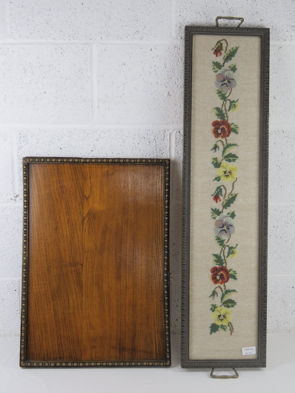 A good oak tray c1930s, measuring 58 x 41cm together with a glazed needle point panel,