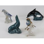 A Poole Sea Lion figurine, together with a Poole Dolphin and two ceramic birds,