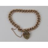 A 9ct rose gold charm bracelet having fine sprung release heart padlock clasp,