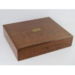 A good oak cutlery box with countersunk blank brass cartouche to the lid, contents deficient,