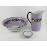 A Soho Pottery Solian ware three piece wash jug, bowl and soap dish in a banded Art Deco design.