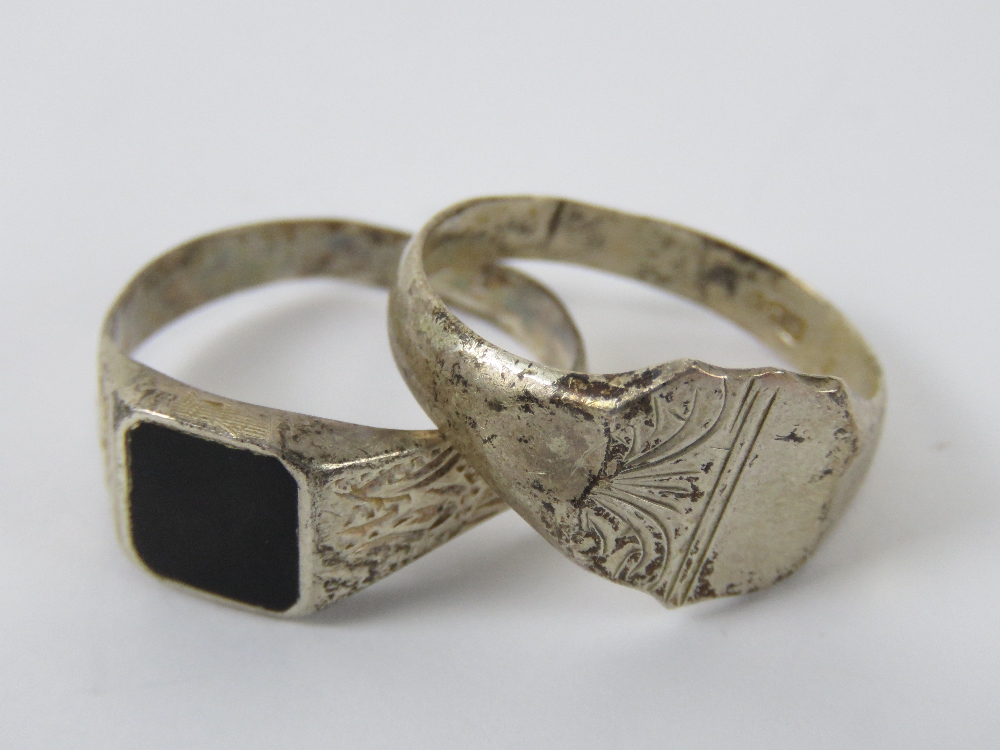 Two silver signet rings, one set with onyx, stamped 925, size S, the other having shield front,