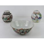 An Oriental bowl having black ground with pink and green floral design upon, character mark to base,