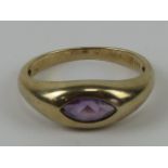 A 9ct gold amethyst ring, the marquise cut amethyst a good purple hew in rub over setting,