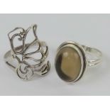 Two silver rings, one having open butterfly design, size R, the other having central cabachon,