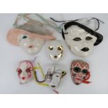 A quantity of decorative wall masks including an enamelled brass example. Six items.