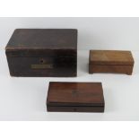 A compass set within fitted wooden box together with a wooden musical box and a wooden stationary