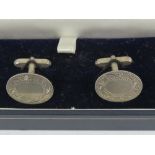 A pair of unengraved silver cufflinks in presentation box.