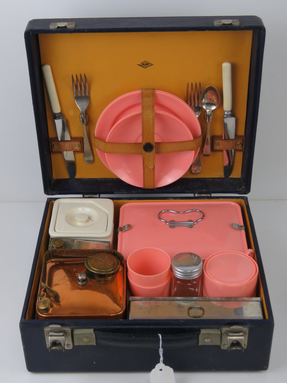 A vintage picnic case by Ilat with contents including beakers, teacups, storage boxes, plates,