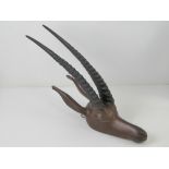 A carved wooden African gazelle head having ebonised antlers, approx 42cm in length.