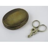 A brass snuff box of oval form with hinged lid, 8cm wide. Together with a cigar cutter. Two items.