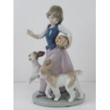 Lladro figurine 5761 'Out For A Romp' a girl with two dogs and a basket of flowers under her arm,