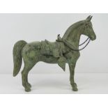 A 19th century cast metal horse in Eurasian saddle and bridle, 24cm high, 28cm in length,