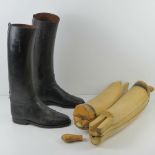 A pair of black leather riding boots, having interior finger pulls,