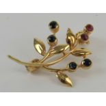A delightful contemporary 9ct gold brooch of floral form set with sapphires and rubies,