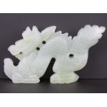 A carved celadon jade figure of a dragon, approx 11.5cm in length, 6.5cm high, 1.3cm wide, 127.5g.