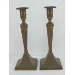 A good stepped pair of brass Georgian style candlesticks raised over stepped base, 26cm high.