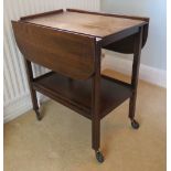 A c1950s drop leaf wheeled tea trolley with undershelf, 64" wide.