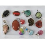 A quantity of assorted hardstone and fossil pendants inc goldstone pendant stamped 925 and