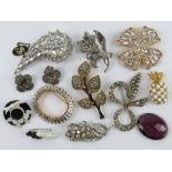 A quantity of assorted 20th century costume brooches including marcasite set flower,