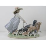 Lladro figurine 6784 'Puppy Parade' girl holding the chain leashes on brown and grey dogs with six