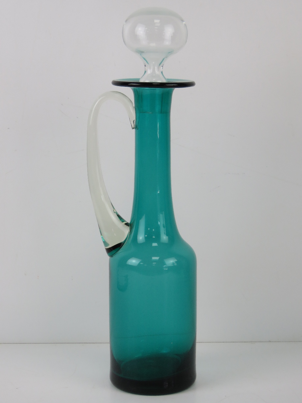 A turquoise and clear glass claret jug standing 39cm high.