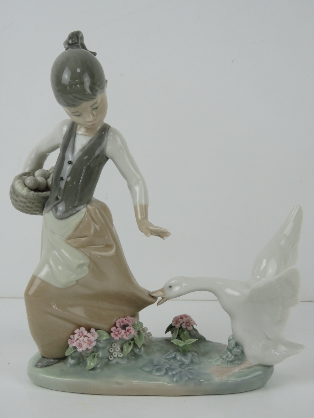 Lladro figurine 1288 'Aggressive Goose' a girl carrying basket of eggs with goose pecking at skirt,